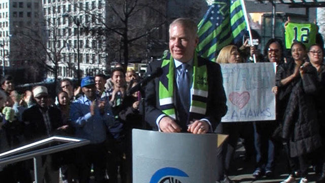 Mayor Ed Murray raises the 12s flag