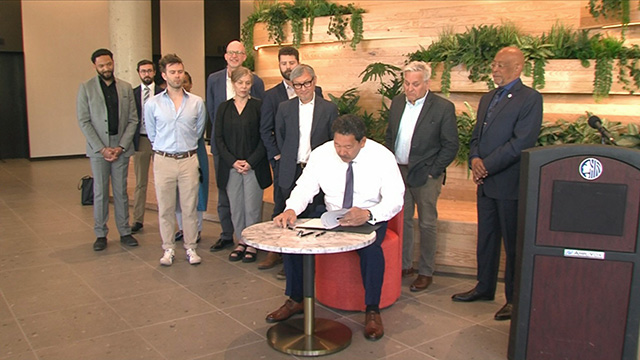 Mayor signs legislation to fill vacant storefronts, extend housing permits